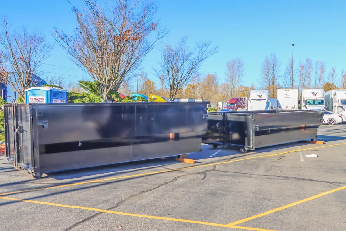 Professional dumpster rental service with roll-off container on residential driveway in Upper Saucon
